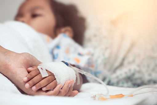 Mother hand holding child hand who have IV solution in the hospital with love and care